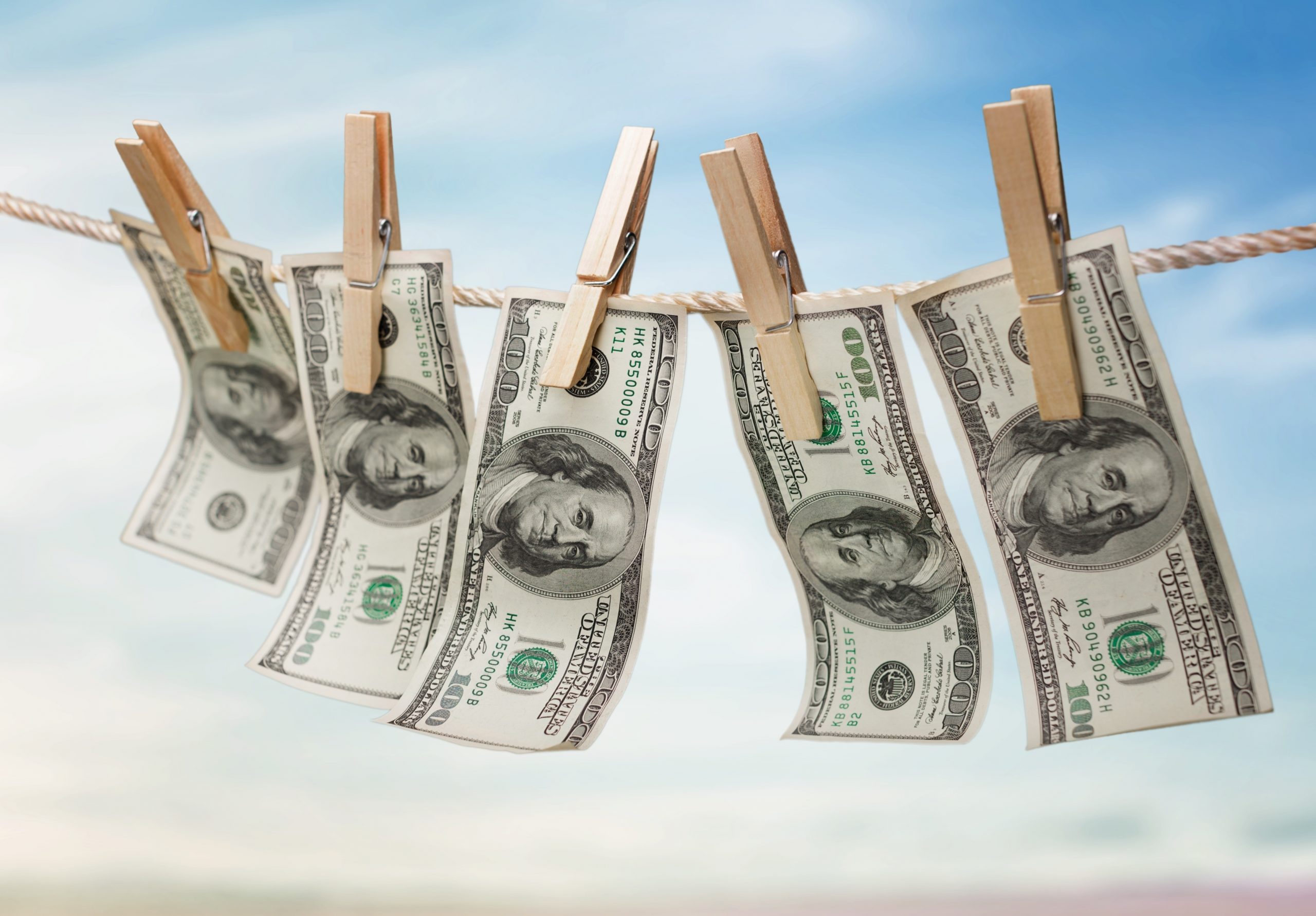 Money Laundering. Hanging $100 bills